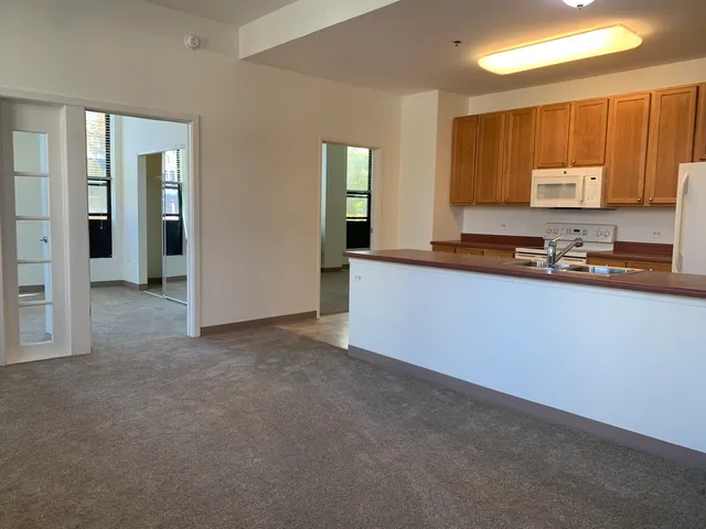 a kitchen with granite countertop a sink and cabinets