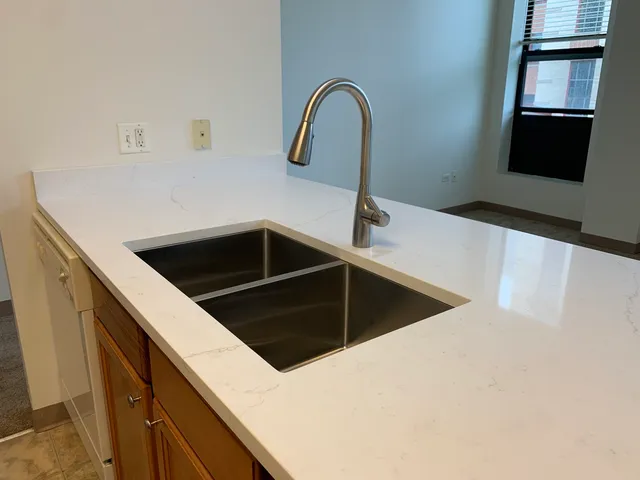 a kitchen with a sink and a refrigerator