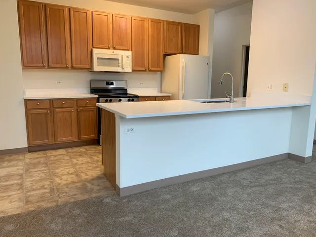 a kitchen with stainless steel appliances a refrigerator and a stove top oven