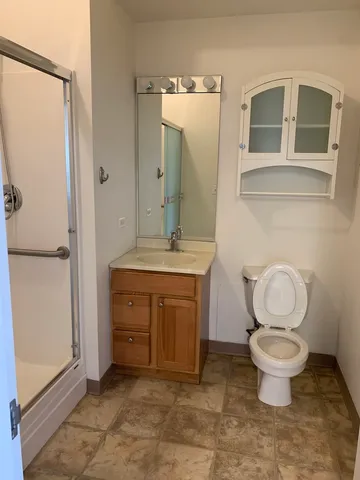 a bathroom with a toilet sink and a mirror