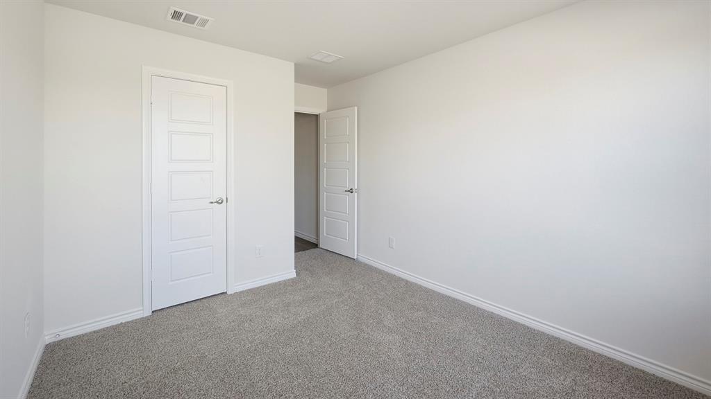 403 Flintlock Road Caddo Mills, TX 75135 - Photo 9 of 26 Unfurnished bedroom with carpet flooring and baseboards