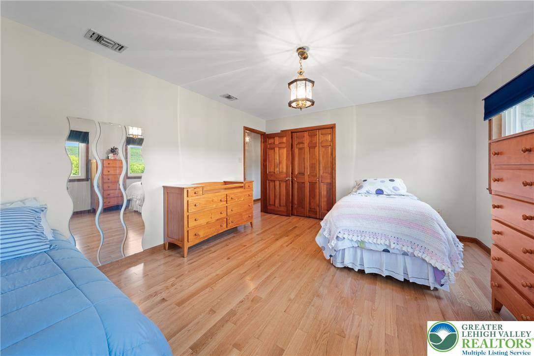 947 Tamenend Road Bath, PA 18014 - Photo 23 of 61 Bright hardwood floors and classic wood closet doors enhance this cozy bedroom.