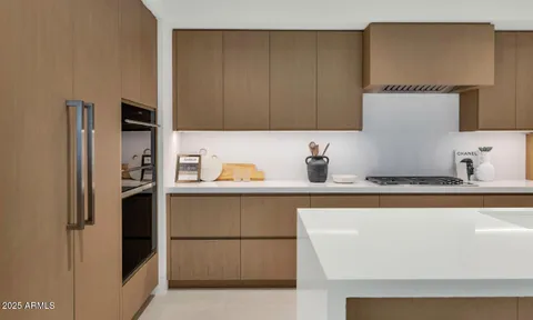 a kitchen with stainless steel appliances granite countertop a refrigerator and a sink