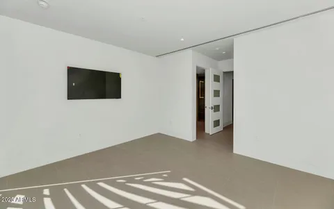 a view of a livingroom with an empty space and a window