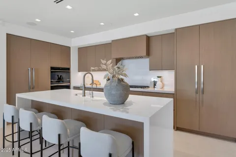 a kitchen with dining table and chairs