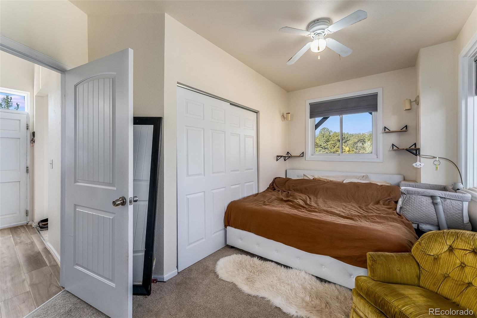 285 Appleby Street Bailey, CO 80421 - Photo 15 of 35 a bedroom with a bed ceiling fan and a window