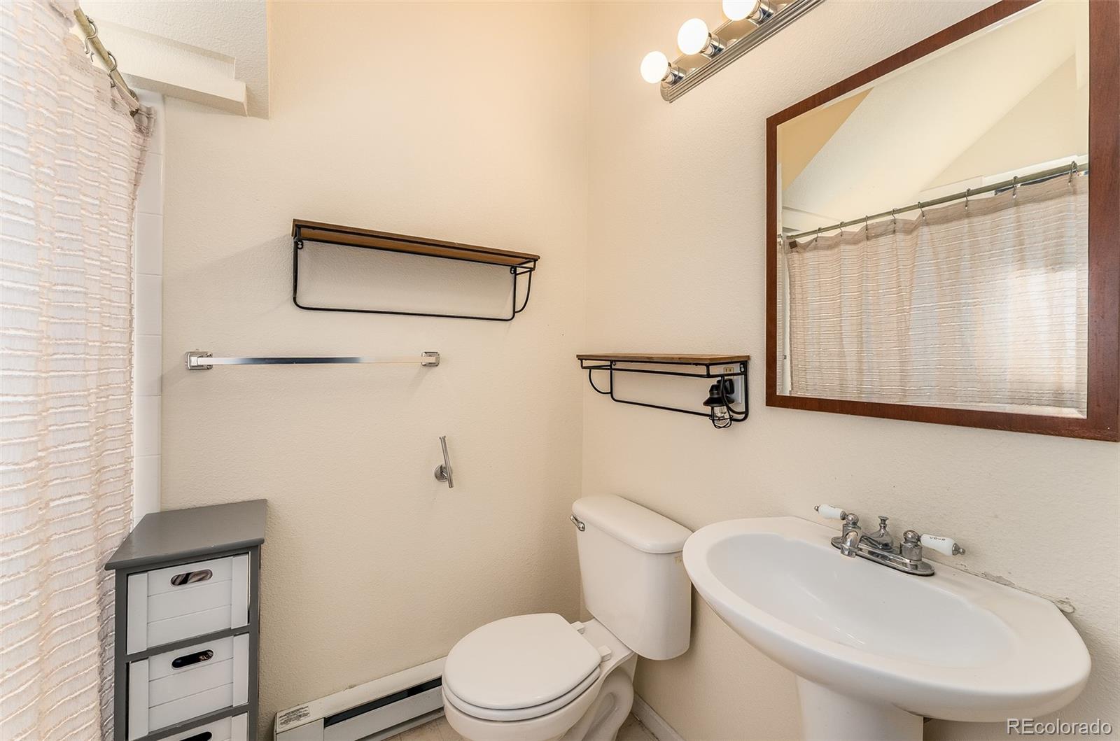 285 Appleby Street Bailey, CO 80421 - Photo 18 of 35 a bathroom with a sink a toilet and shower