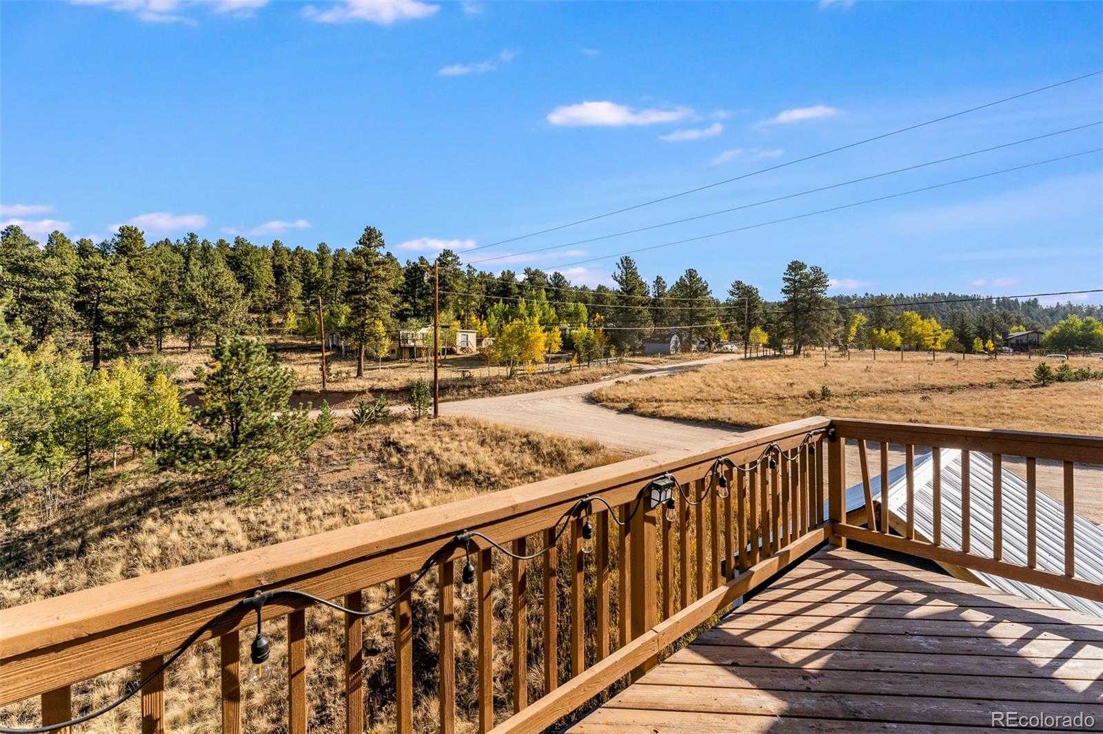 285 Appleby Street Bailey, CO 80421 - Photo 22 of 35 a view of a balcony with wooden floor and city view