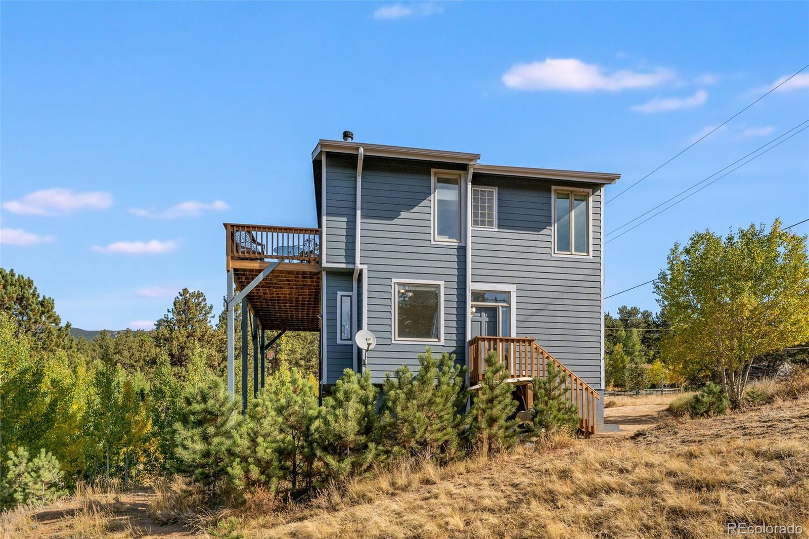 285 Appleby Street Bailey, CO 80421 - Photo 27 of 35 a backyard of a house with table and chairs