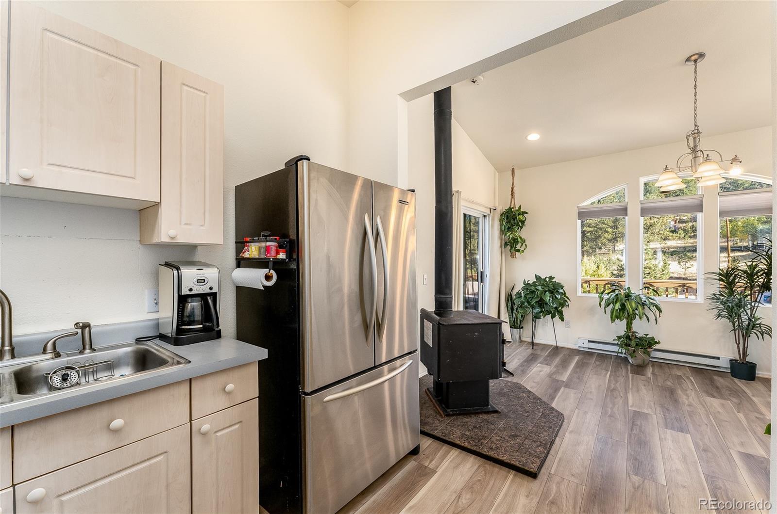 285 Appleby Street Bailey, CO 80421 - Photo 7 of 35 a kitchen with a refrigerator and a sink
