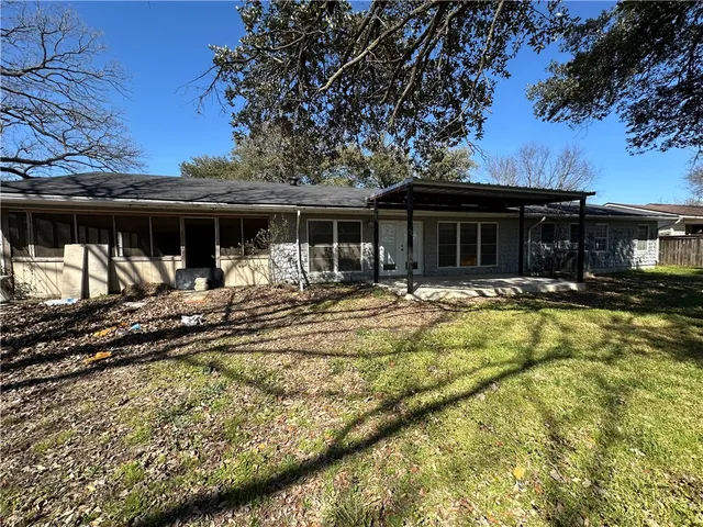 a view of a house with pool and sitting area