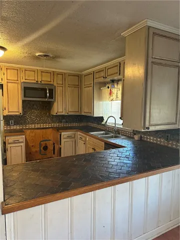 a kitchen with granite countertop a sink and cabinets