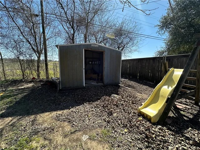 a view of a backyard with a large tree