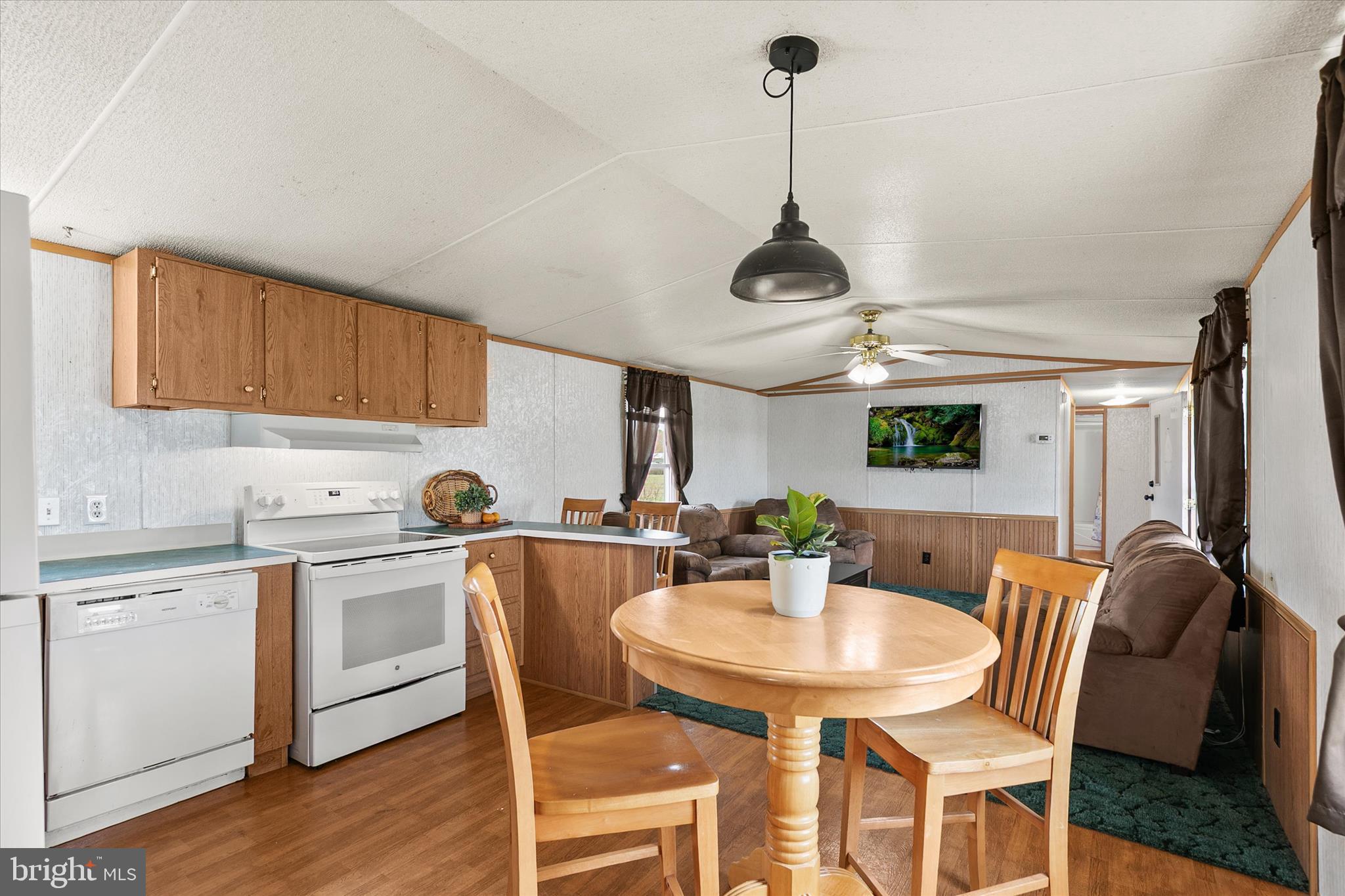 36999 Hudson Road Selbyville, DE 19975 - Photo 12 of 28 a kitchen with stainless steel appliances a dining table chairs and white cabinets