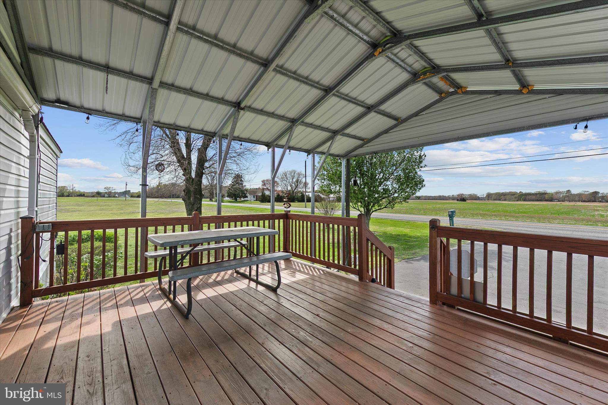 36999 Hudson Road Selbyville, DE 19975 - Photo 3 of 28 a view of a deck with wooden floor and outdoor seating