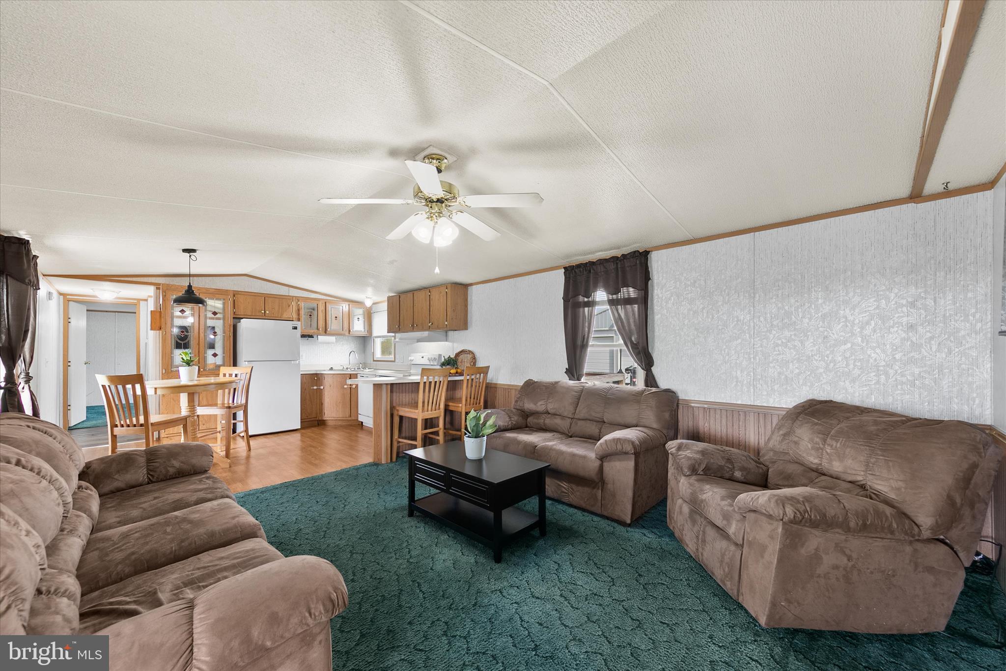 36999 Hudson Road Selbyville, DE 19975 - Photo 7 of 28 a living room with furniture and a chandelier