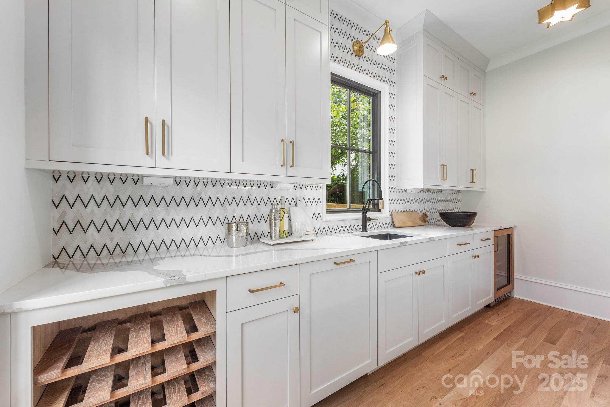 4021 Ridgecrest Avenue Charlotte, NC 28211 - Photo 18 of 47 a kitchen with a sink and cabinets