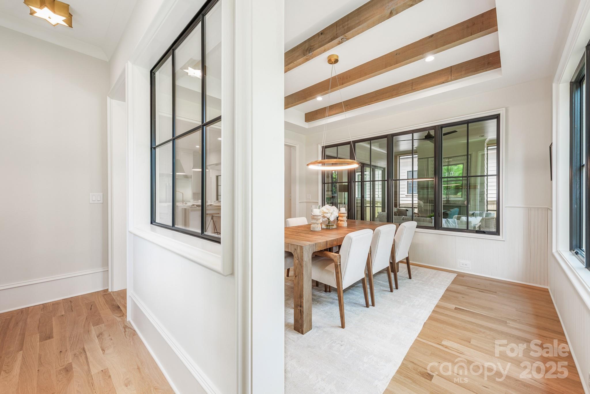 4021 Ridgecrest Avenue Charlotte, NC 28211 - Photo 19 of 47 a dining room with furniture and wooden floor