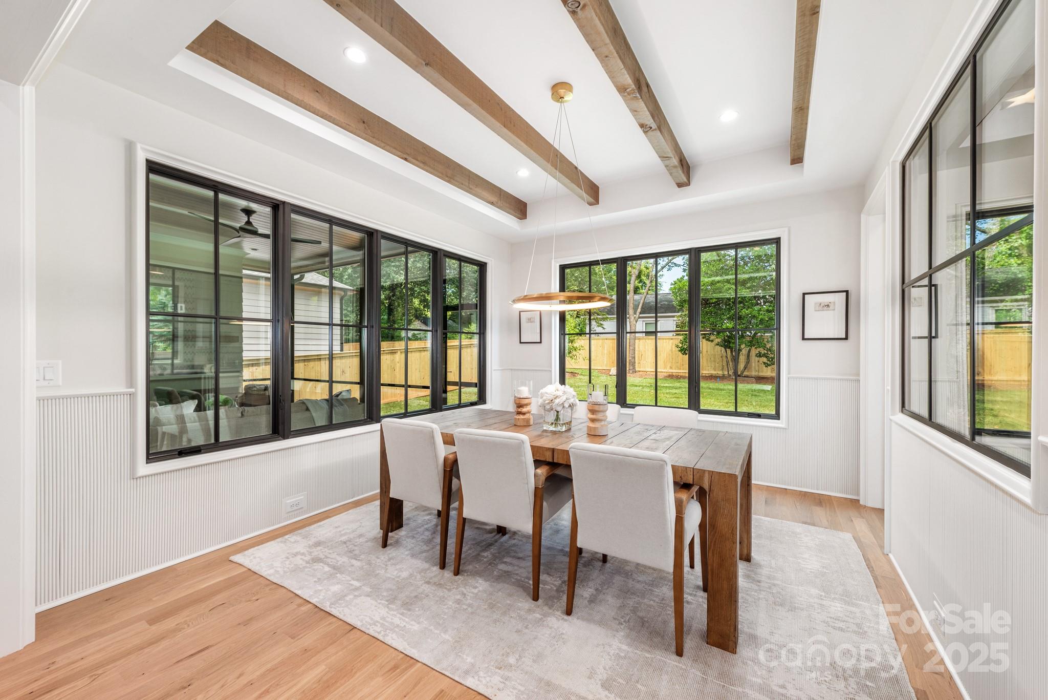4021 Ridgecrest Avenue Charlotte, NC 28211 - Photo 20 of 47 a view of a dining room with furniture large windows and wooden floor