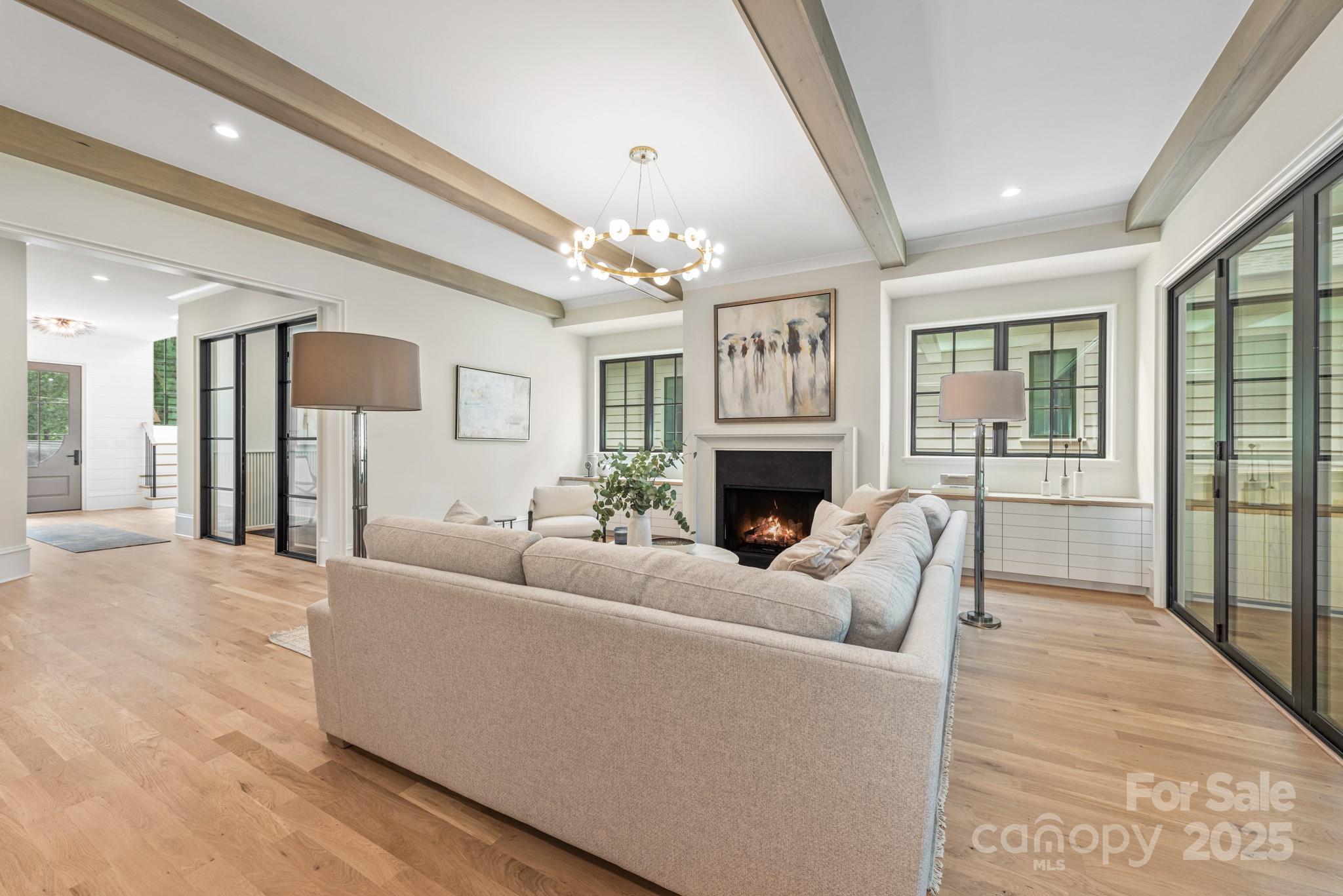 4021 Ridgecrest Avenue Charlotte, NC 28211 - Photo 23 of 47 a living room with furniture a fireplace and a chandelier
