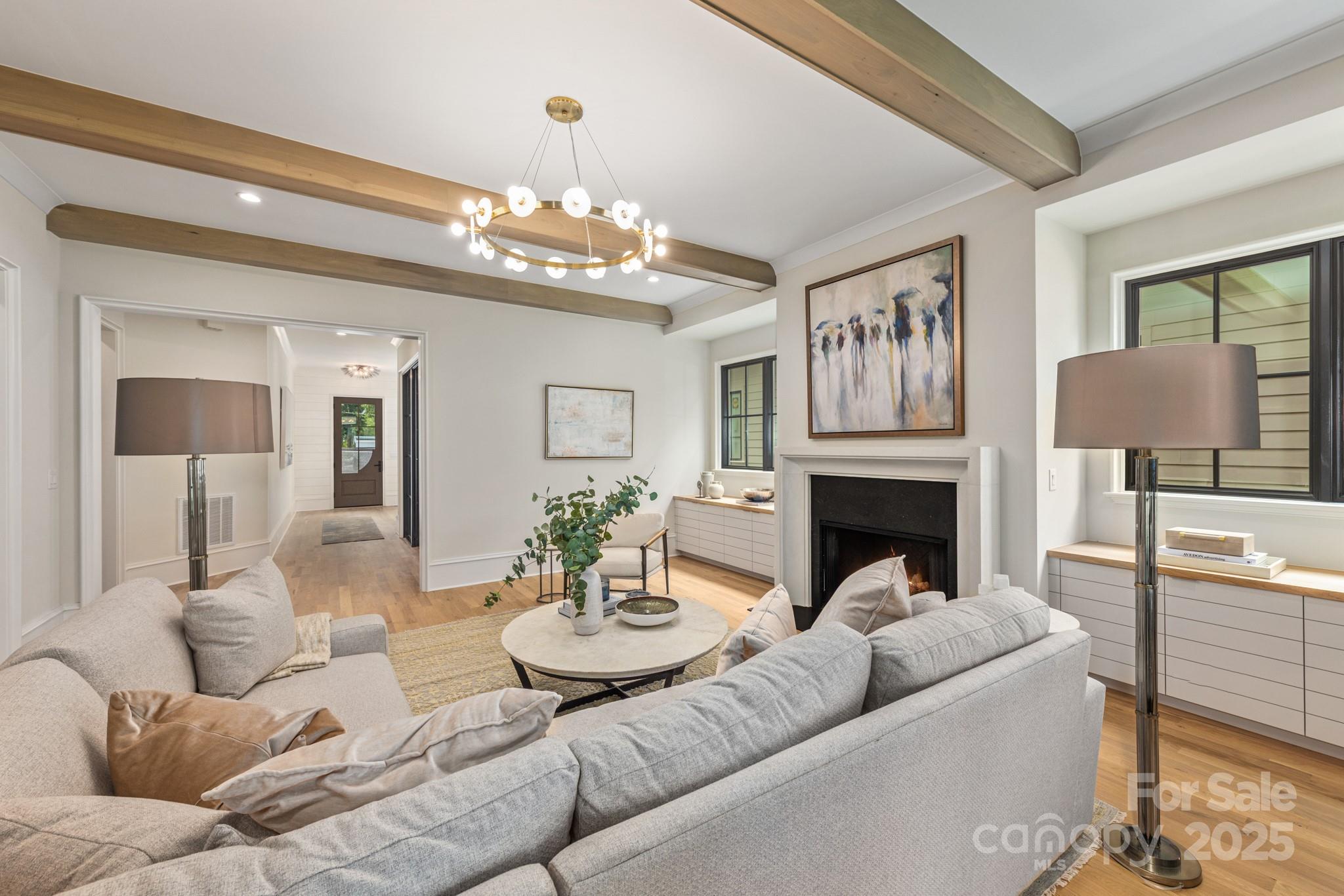 4021 Ridgecrest Avenue Charlotte, NC 28211 - Photo 24 of 47 a living room with furniture chandelier and fireplace