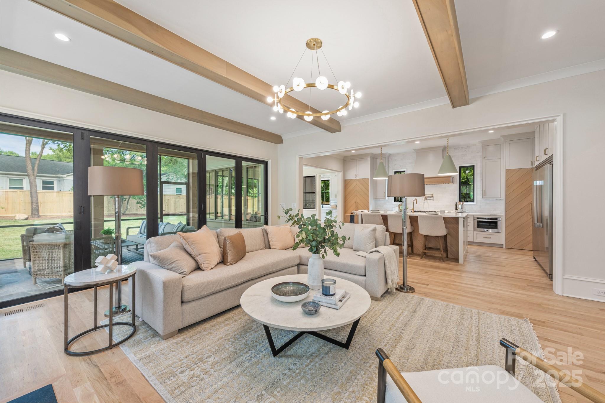 4021 Ridgecrest Avenue Charlotte, NC 28211 - Photo 26 of 47 a living room with furniture chandelier and large windows
