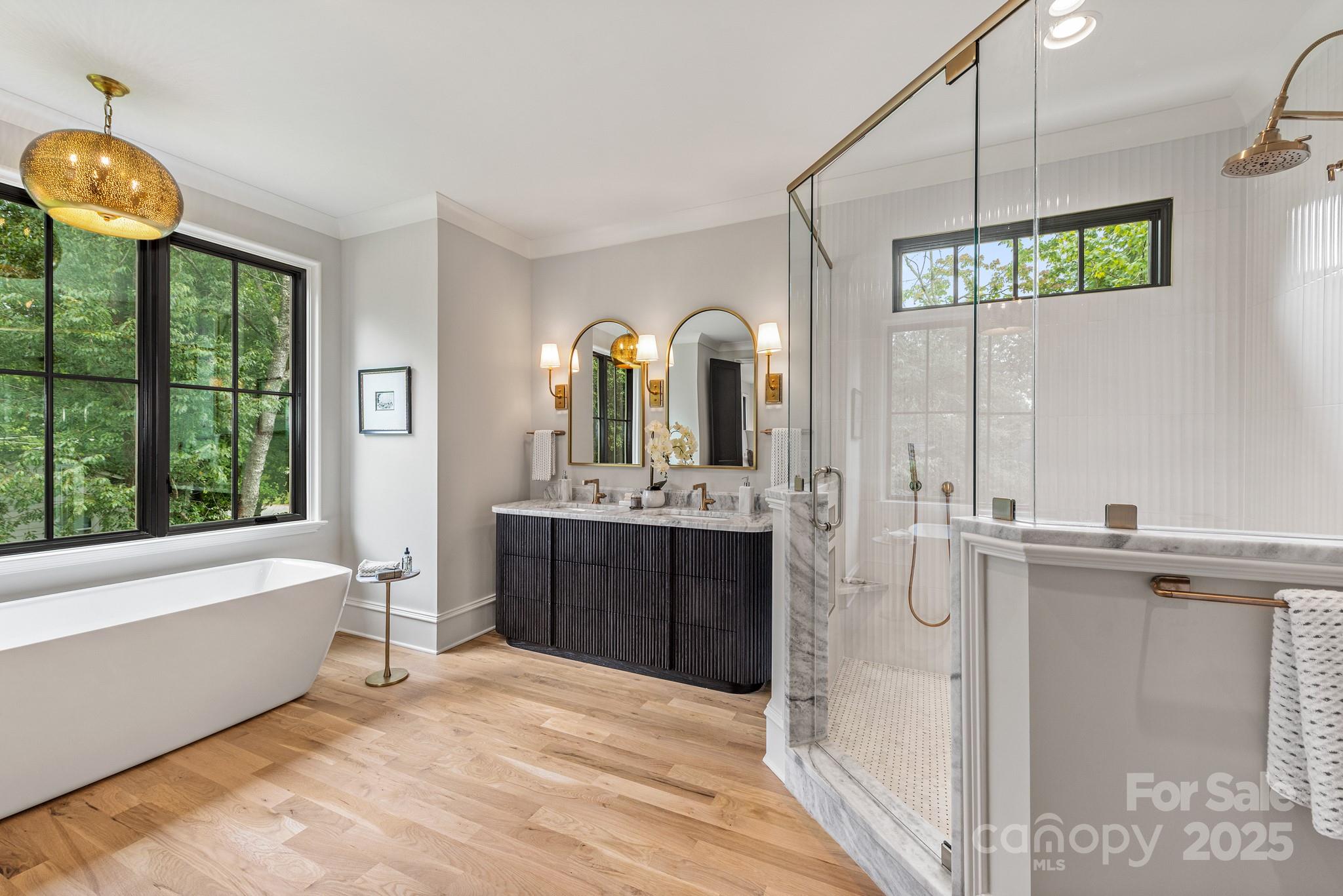 4021 Ridgecrest Avenue Charlotte, NC 28211 - Photo 36 of 47 a bathroom with a tub sink and mirror