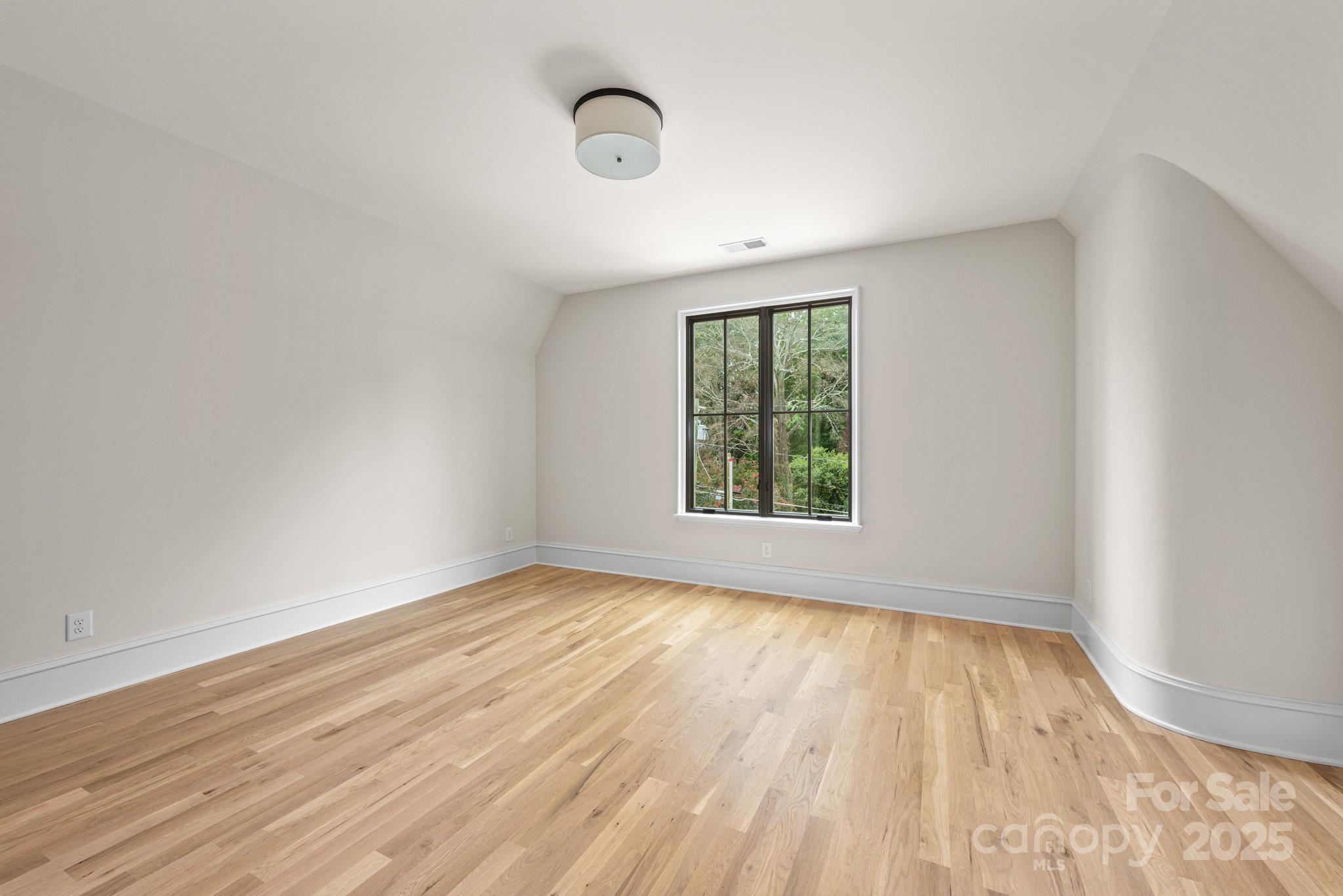 4021 Ridgecrest Avenue Charlotte, NC 28211 - Photo 39 of 47 an empty room with wooden floor and windows