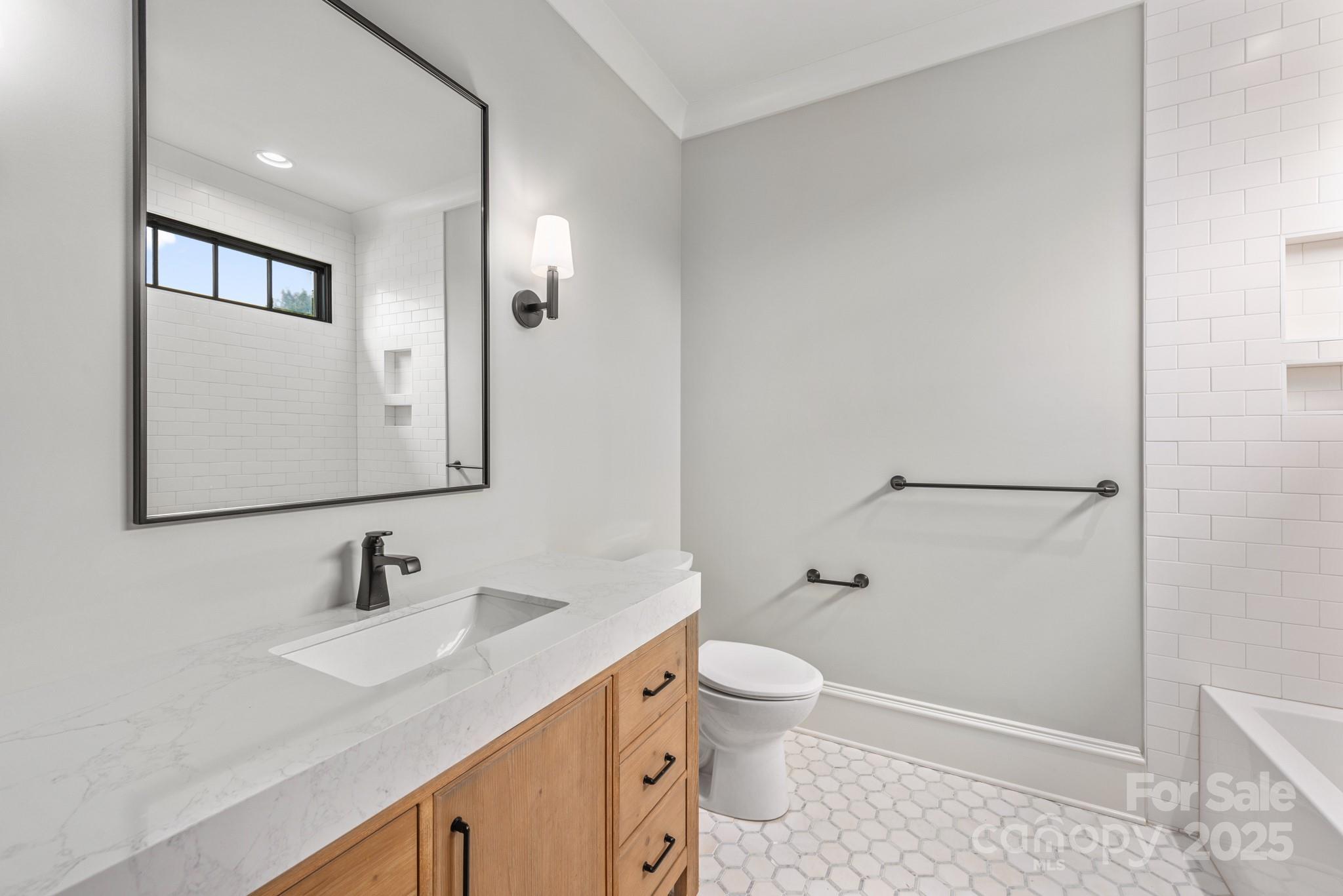4021 Ridgecrest Avenue Charlotte, NC 28211 - Photo 40 of 47 a bathroom with a sink toilet and shower