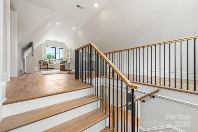 a living room with couches and a coffee table with wooden floor