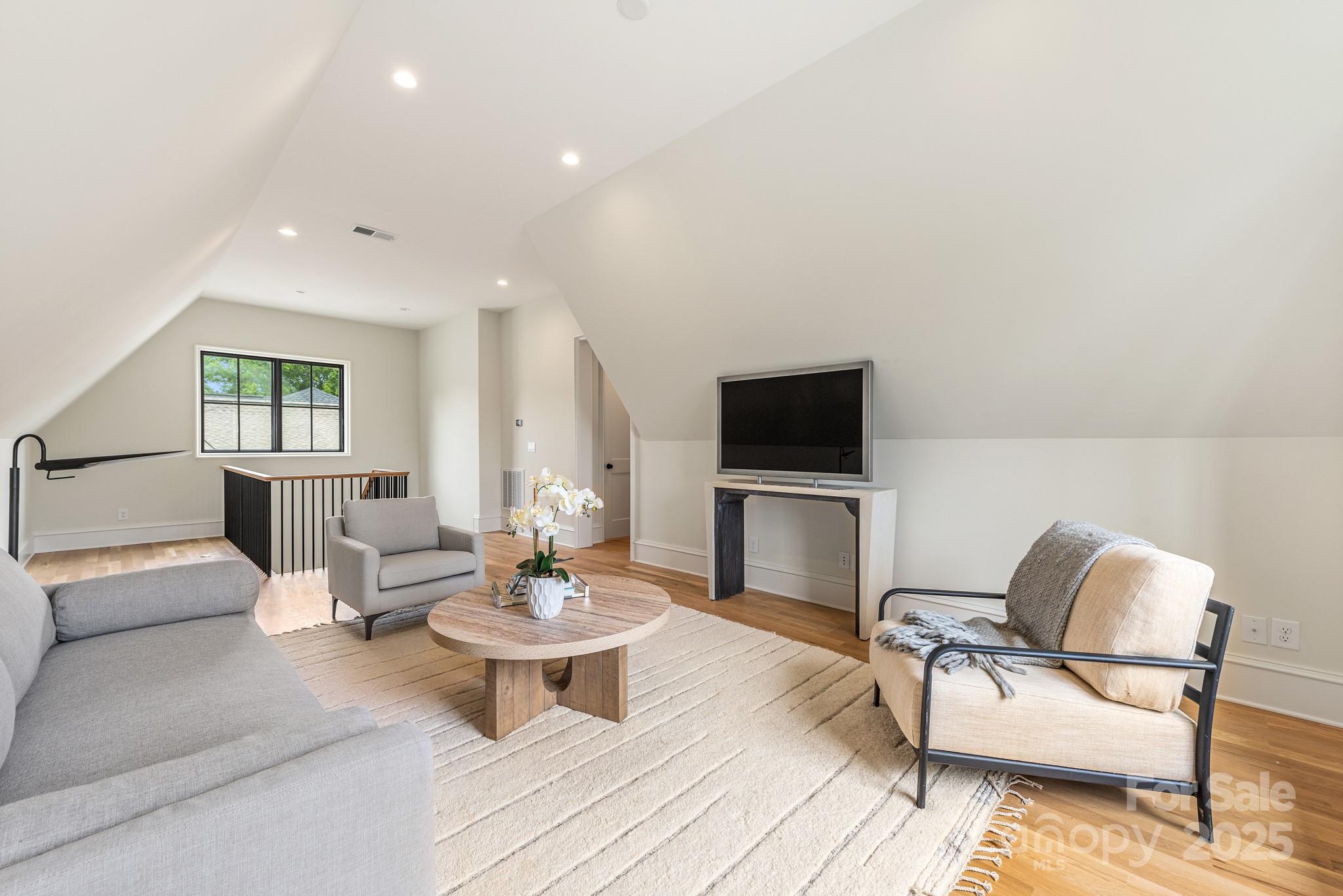 4021 Ridgecrest Avenue Charlotte, NC 28211 - Photo 46 of 47 a living room with furniture and a wooden floor