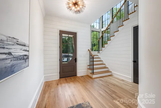 a view of a livingroom with wooden floor and stairs