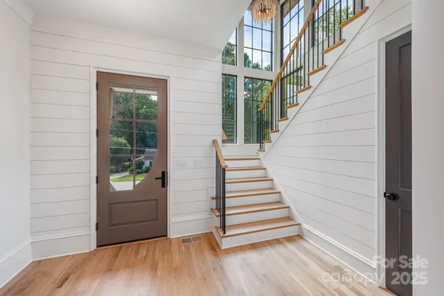 a view of entryway with stairs and wooden floor
