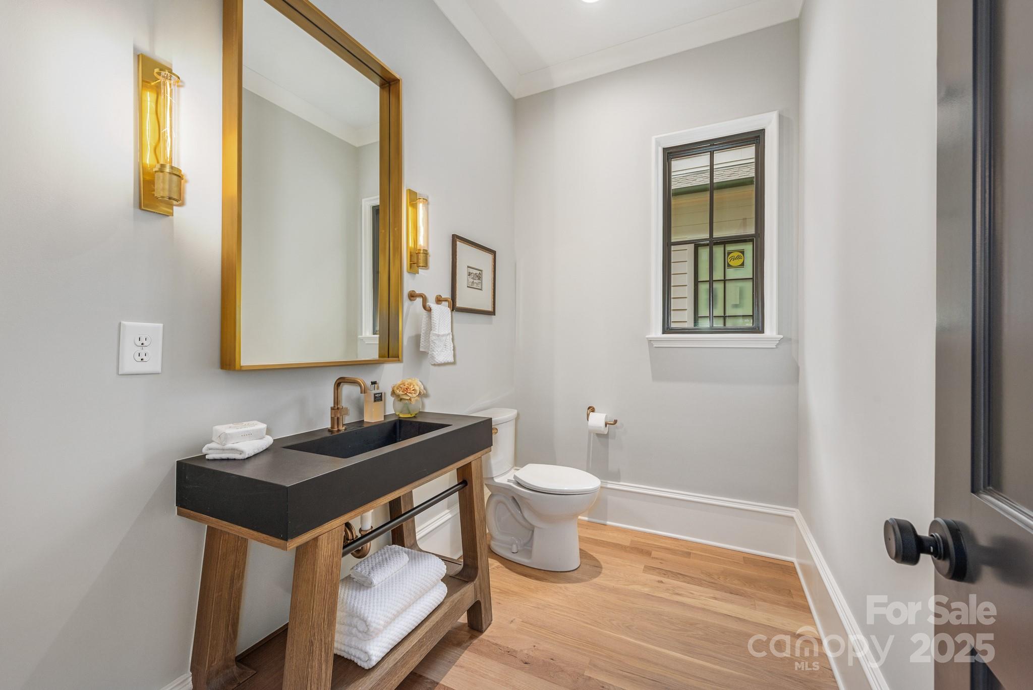 4021 Ridgecrest Avenue Charlotte, NC 28211 - Photo 7 of 47 a bathroom with a sink toilet and mirror