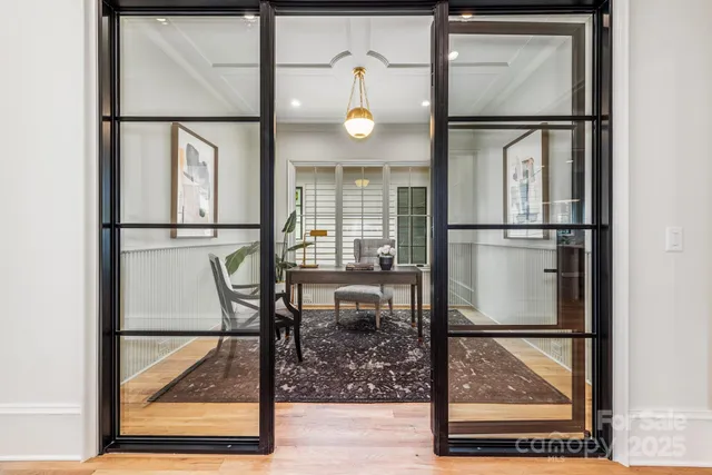 a view of a hallway with wooden floor and dining table with wooden floor