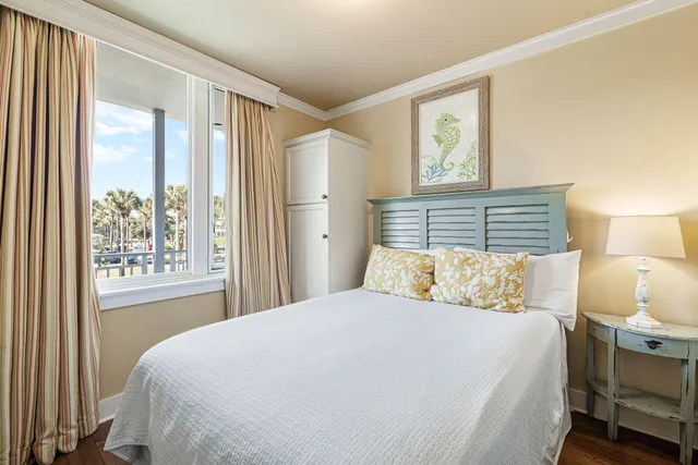 a bedroom with a large bed and a window