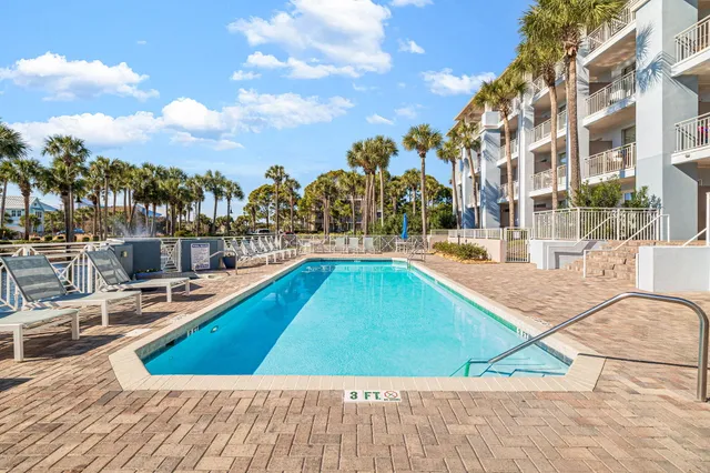 a view of a swimming pool with outdoor seating