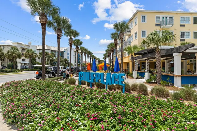 a view of the patio with dining table and chairs under an umbrella