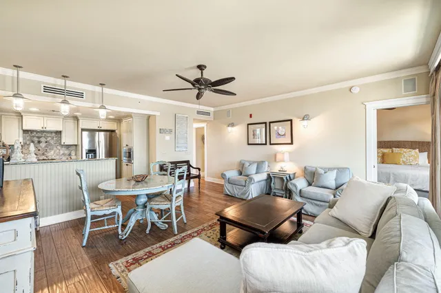 a living room with furniture a ceiling fan and a rug