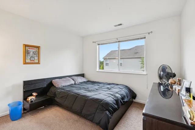 a bedroom with bed and window