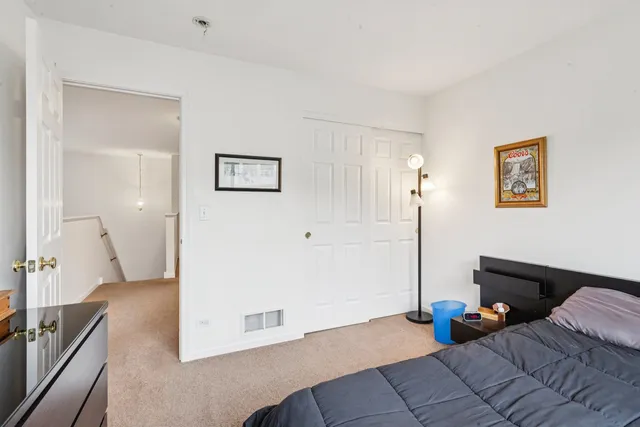 a bedroom with furniture and a potted plant