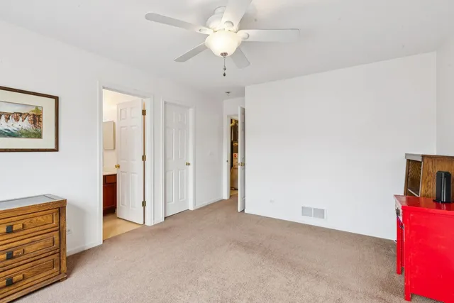 a view of empty room with ceiling fan