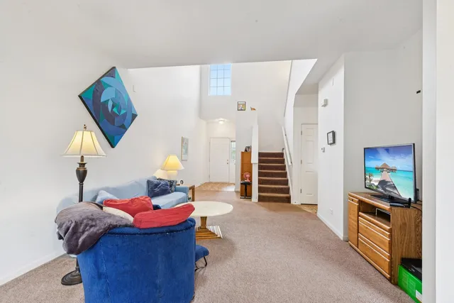 a living room with furniture and a chandelier