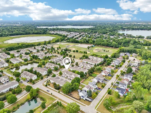 an aerial view of residential houses with outdoor space and street view