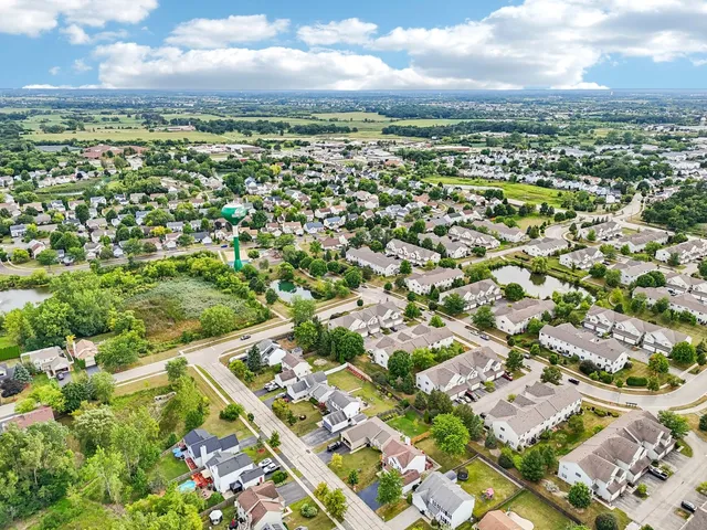 an aerial view of residential houses with outdoor space
