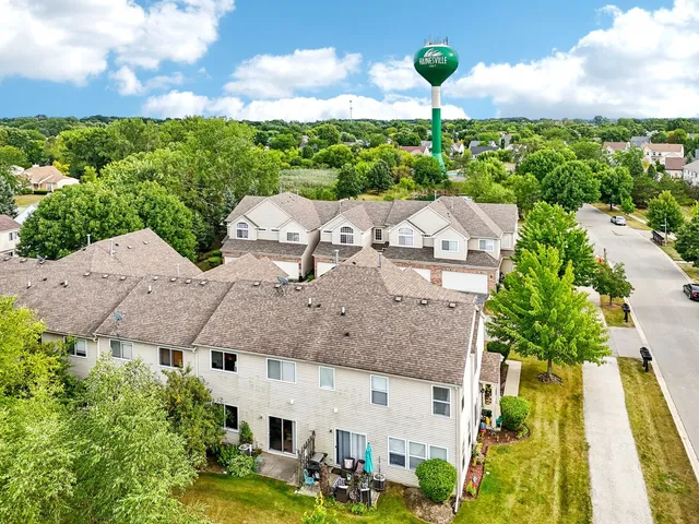 an aerial view of a house with yard swimming pool and outdoor seating