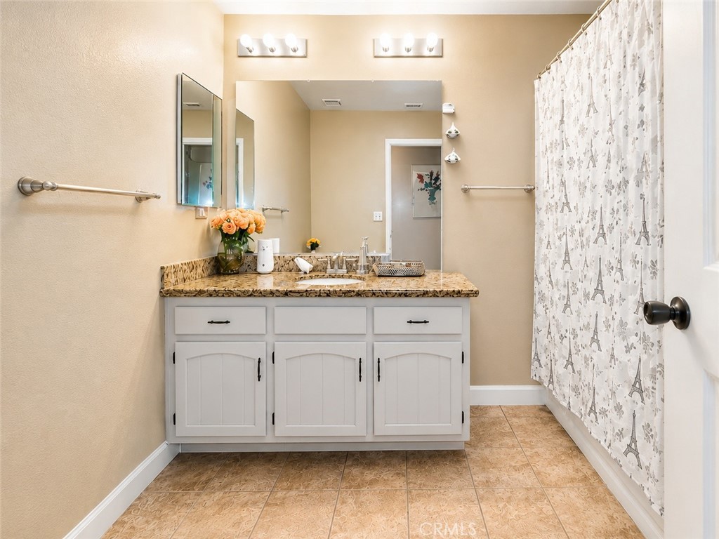 4100 Ahwahnee Court Modesto, CA 95356 - Photo 13 of 34 Spacious bathroom with granite counters, extra vanity space, and clean updated finishes.