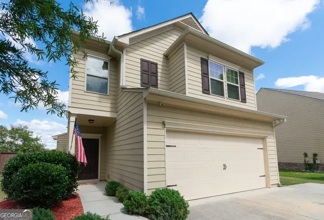a front view of house with trees