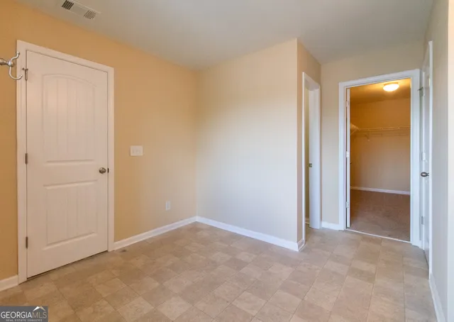 a view of an empty room and closet area