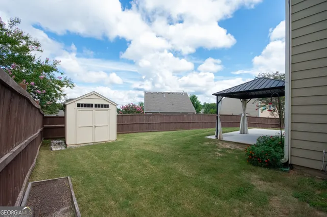 a backyard of a house with table and chairs